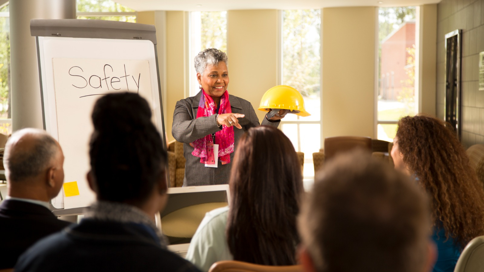 Business safety meeting Woman presenting at safety meeting