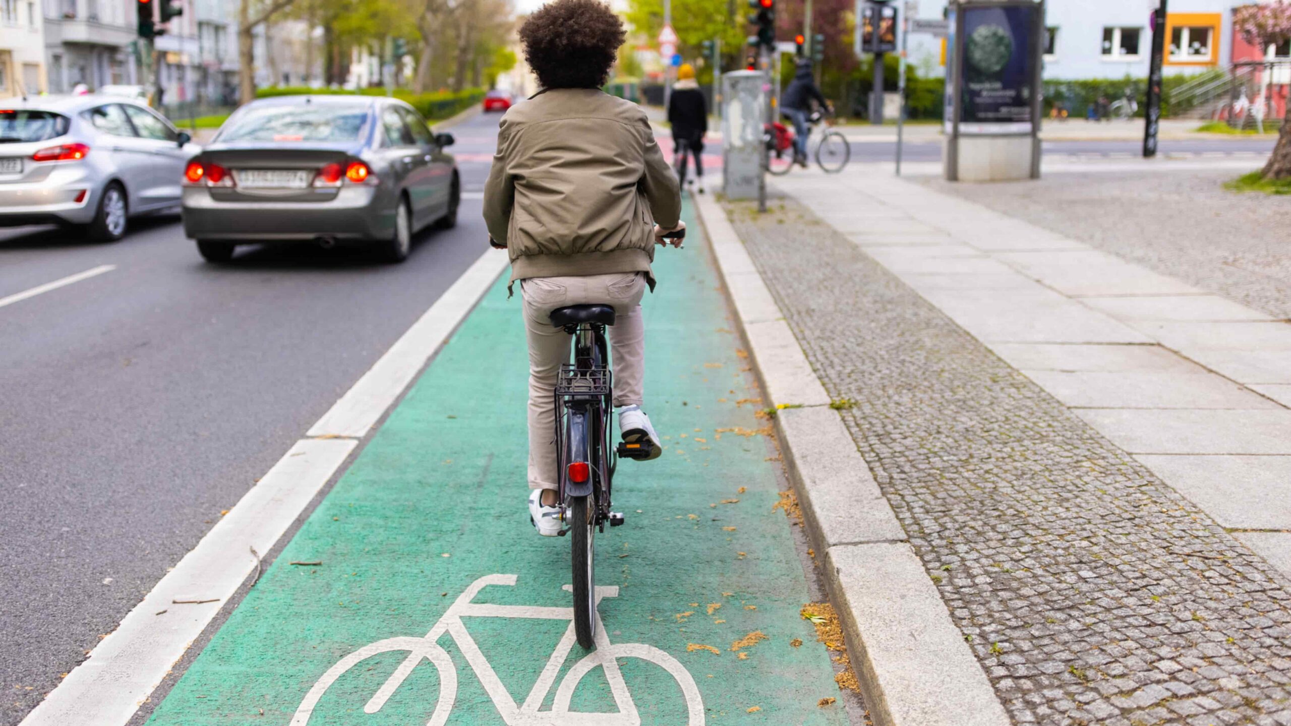 7-1 Blog Image boy riding bicycle in bicycle lane in traffic