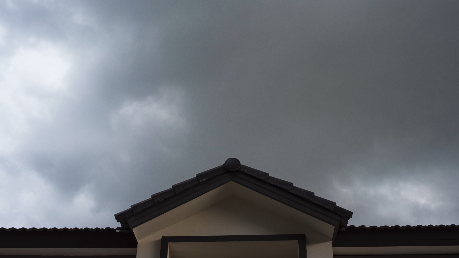 Jan 16 Blog storm cloud gathering over closeup of house